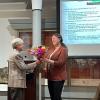 Professor Hosek receiving flowers from the Sisters of Loretto
