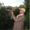 Shadrack holding a camera in the field