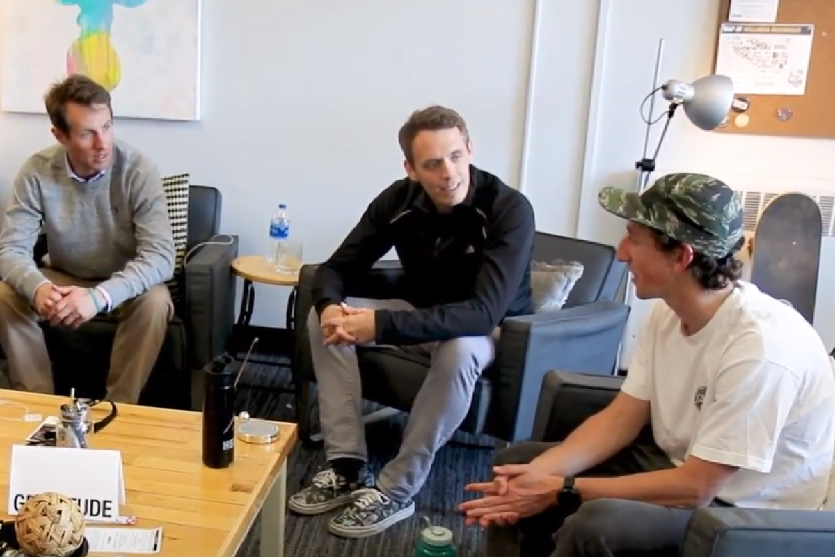three people talking in a circle