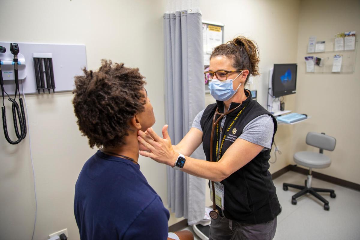 a student being examined by a health care professional