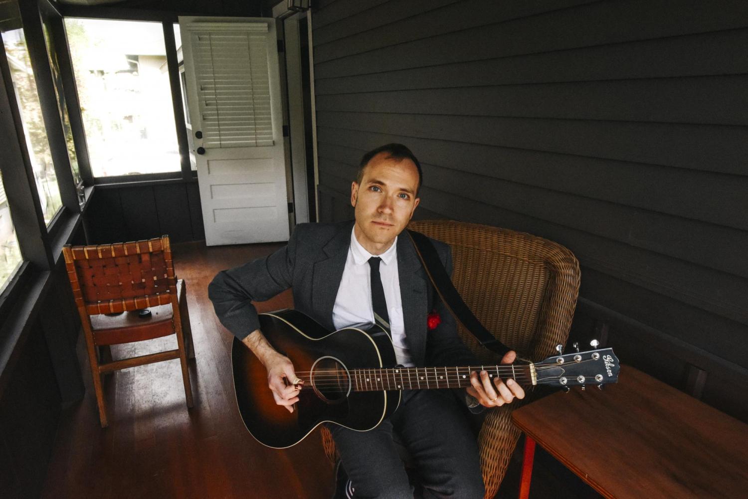 Jeremiah Lockwood playing guitar on Chautauqua porch