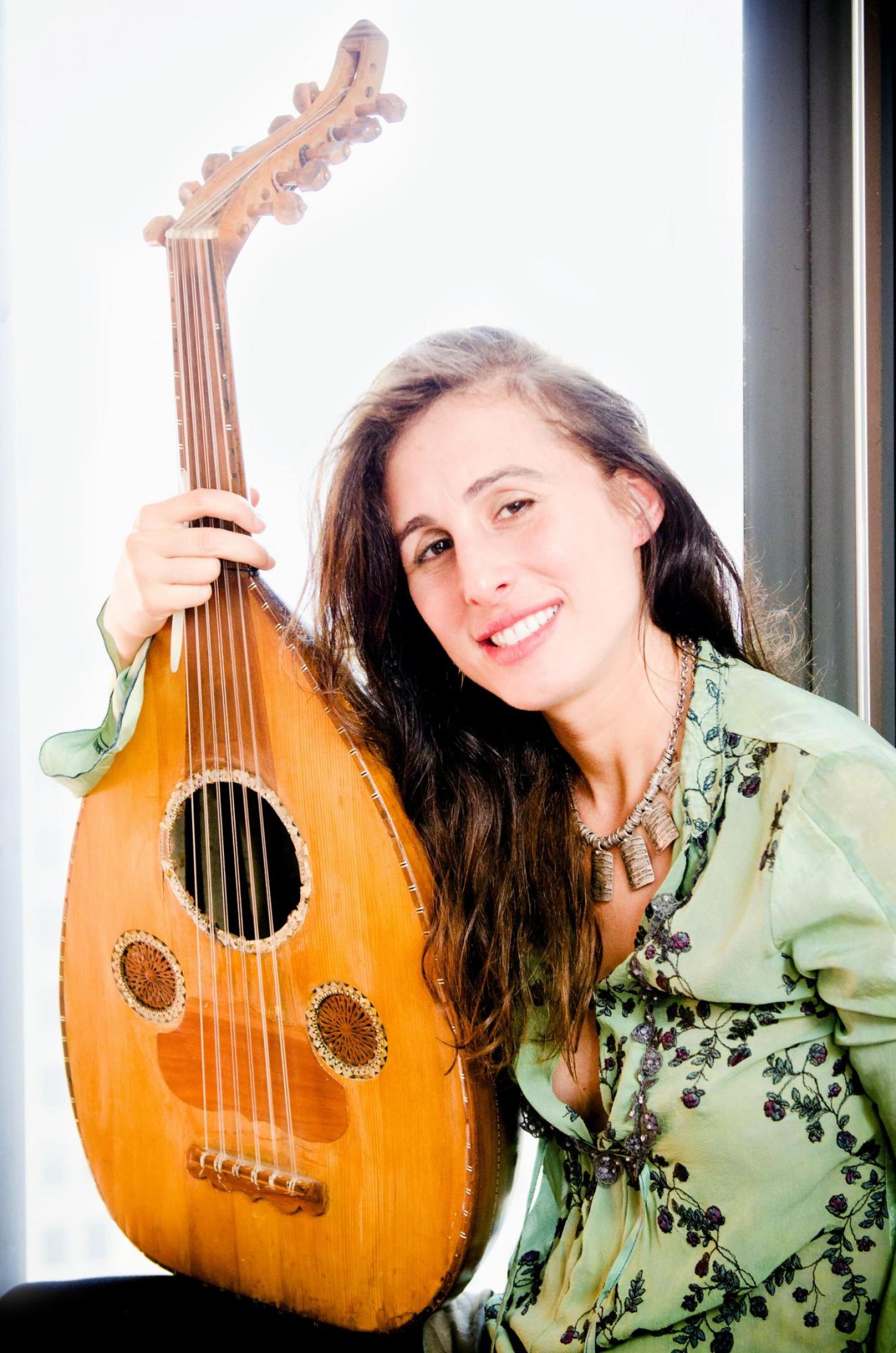Basya Schechter holding an instrument