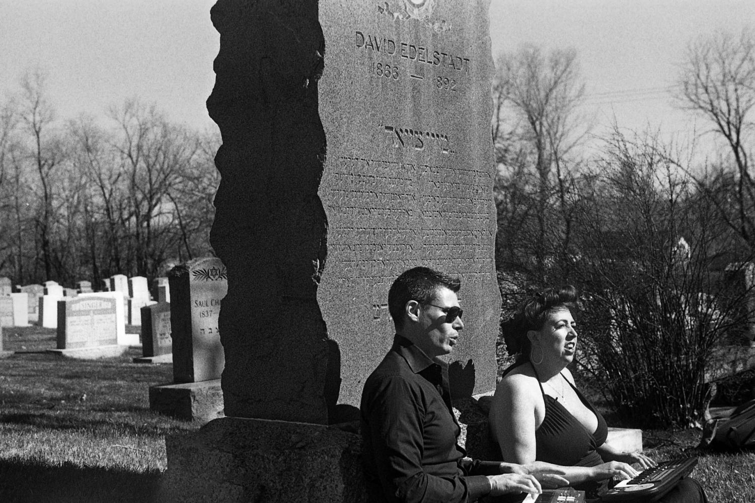 David Shneer and Jewlia Eisenberg sitting at the cemetery