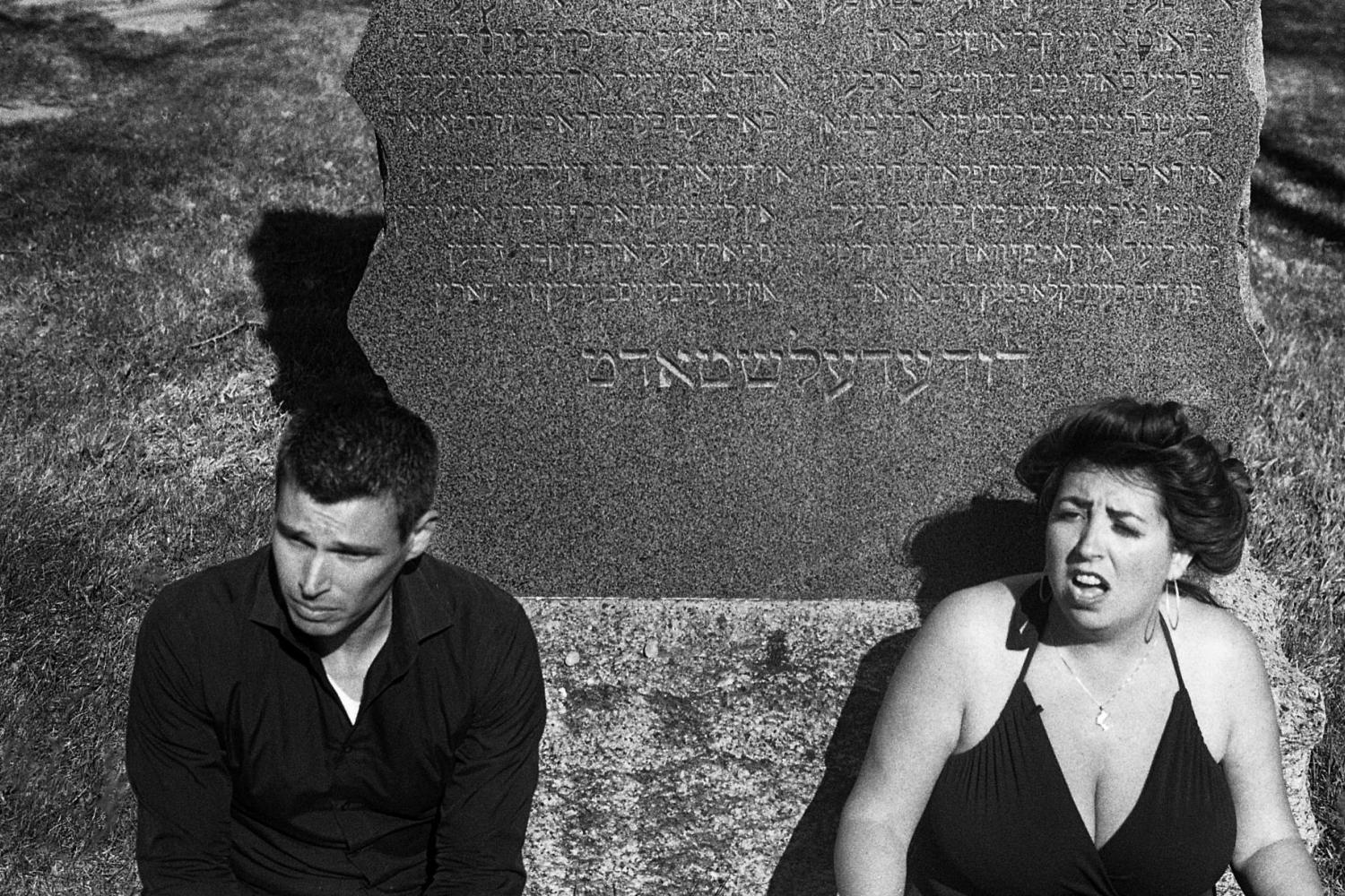 David Shneer and Jewlia Eisenberg sitting at the cemetery