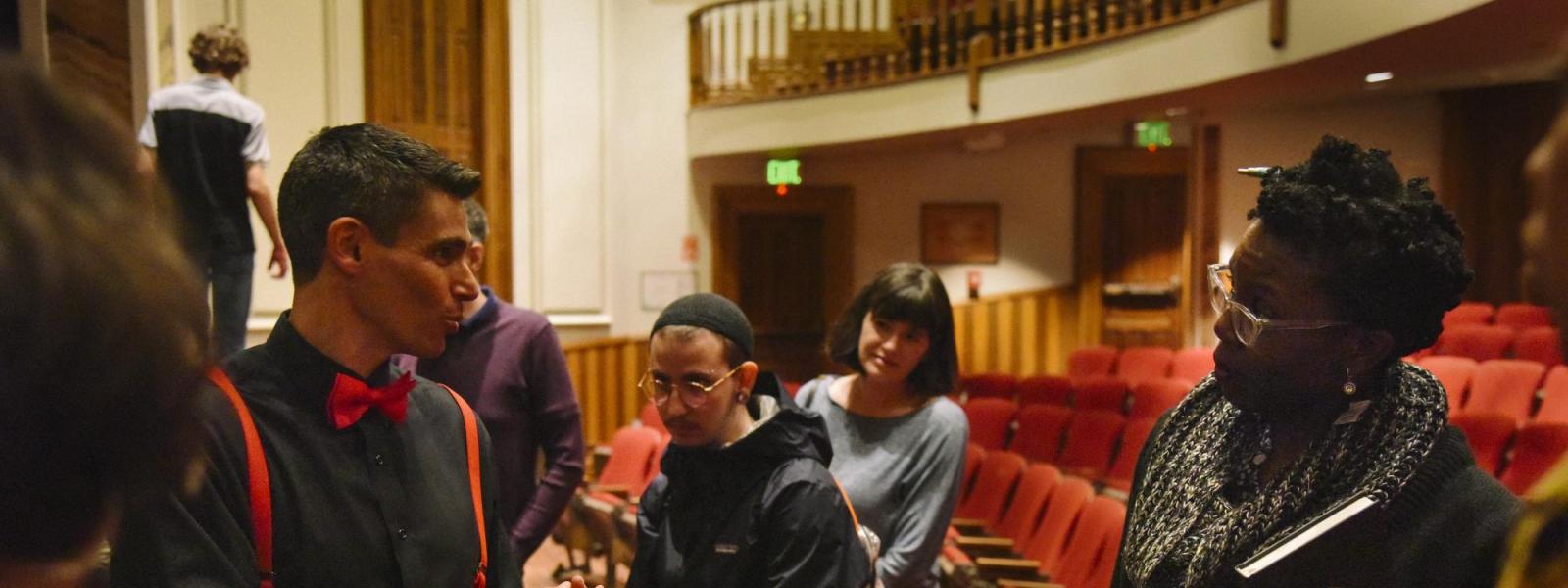 David Shneer talking with some participants at "art is my weapon" event