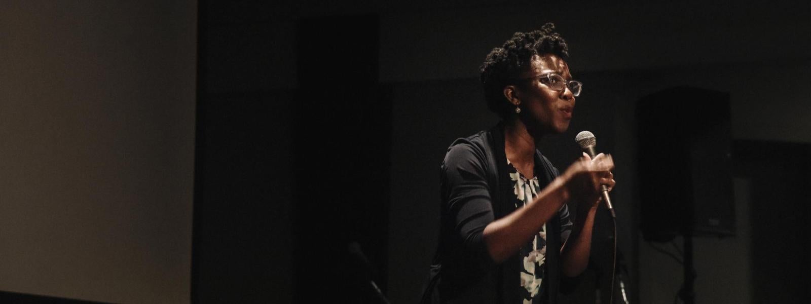 Amma Y. Ghartey-Tagoe Kootin standing on the stage delivering a talk