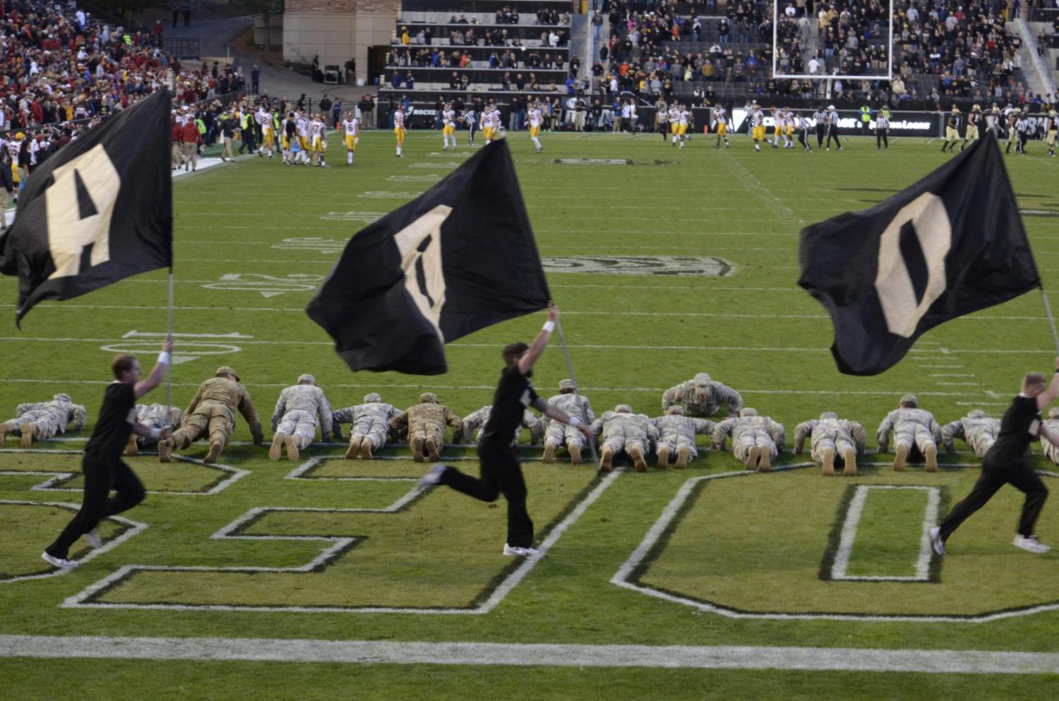 AROTC members doing pushups during the game for every point scored by CU.