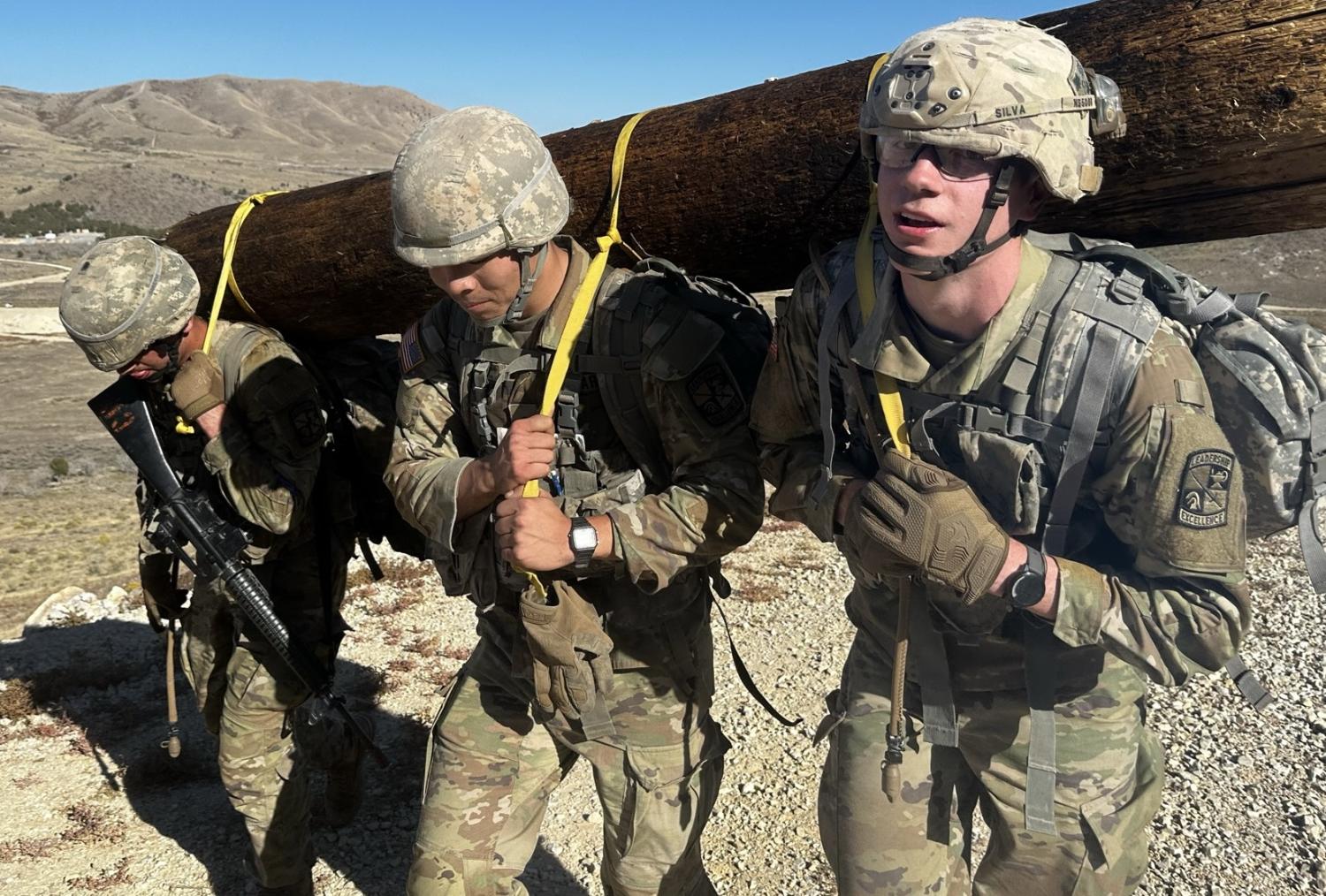 Cadets showing their strength and teamwork as they maneuver a log down a rocky path. Photo courtesy of CPT Nate Wherley.