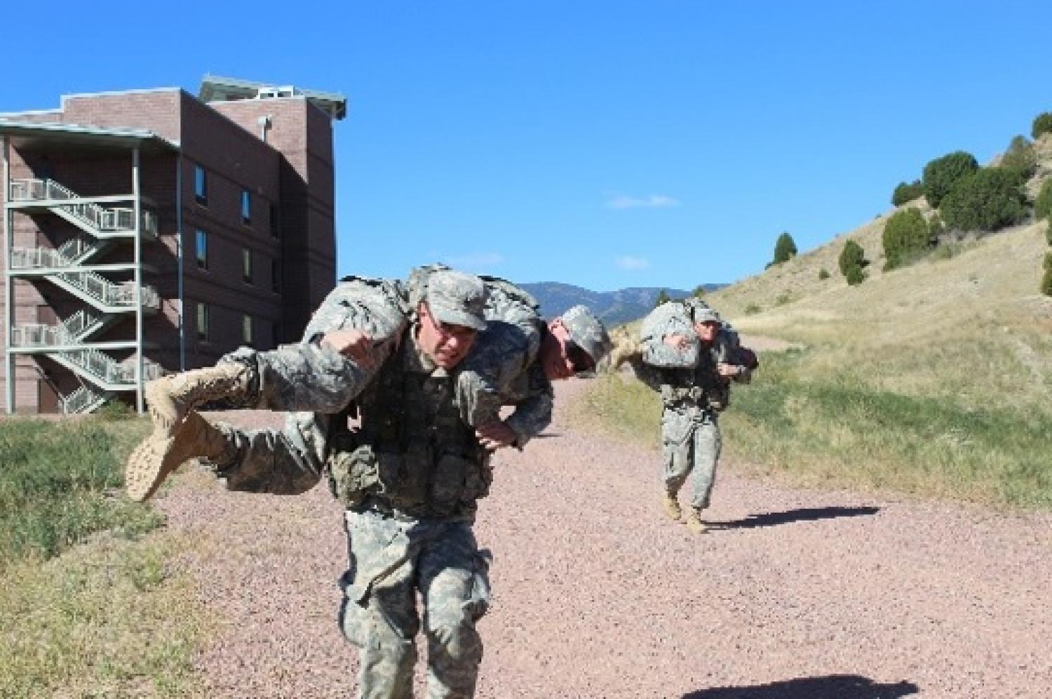 Cadets simulate carrying wounded Cadets during Ranger Challenge.