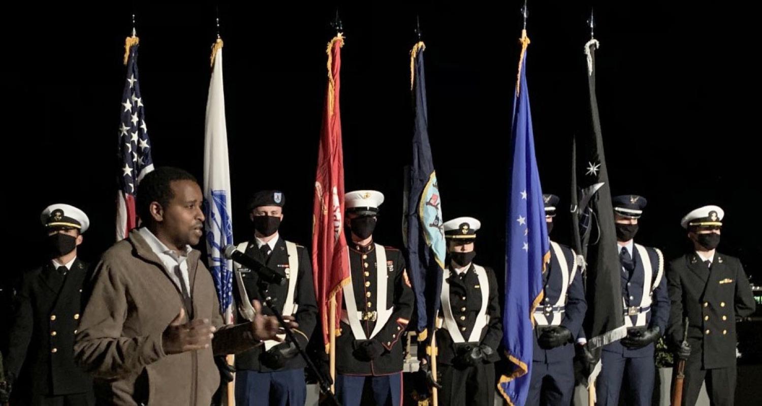 U.S. Representative Joe Neguse making opening comments at the ceremony with the CU ROTC Joint Color Guard at attention. Photo courtesy of Rex Laceby.