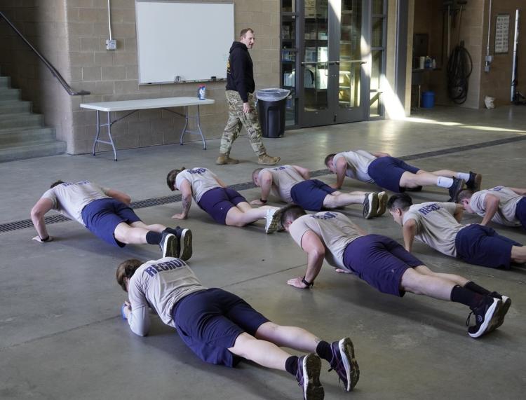 Cadet William Vlad running the firefighter recruits through some PT training – planks. Photo courtesy of CPT Chris Head.