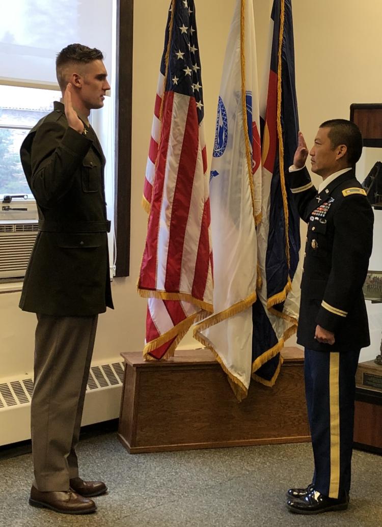 Army ROTC Cadet David Gorman (on left) being sworn in with the Oath of Office by LTC Bryce Kawaguchi (on right). Photo courtesy of the AROTC Golden Buffalo Battalion.