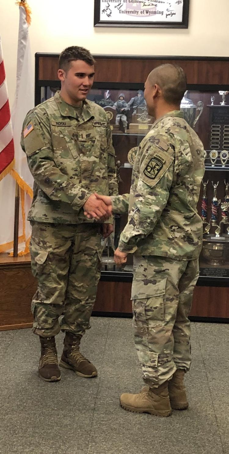 Army ROTC Cadet Finn Roou (on left) shaking hands with LTC Bryce Kawaguchi (on right) after being sworn in as a Second Lieutenant. Photo courtesy of the AROTC Golden Buffalo Battalion.