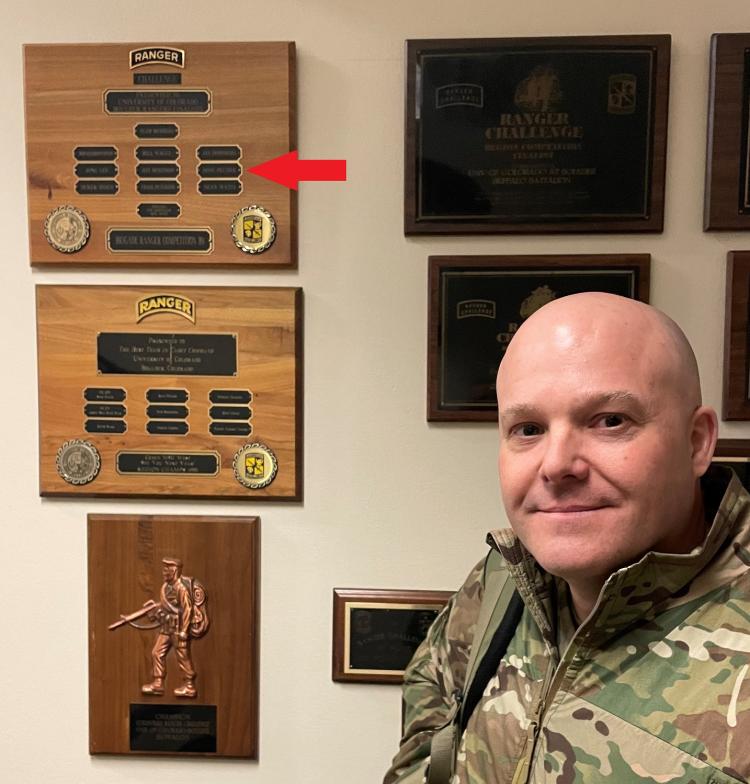 BG Peltier standing in front of the Brigade Ranger Competition Finalist plaque from 1989 in which he was a team member (plaque is hung in the AROTC Cadet Lounge). Photo courtesy of LTC Bryce Kawaguchi.