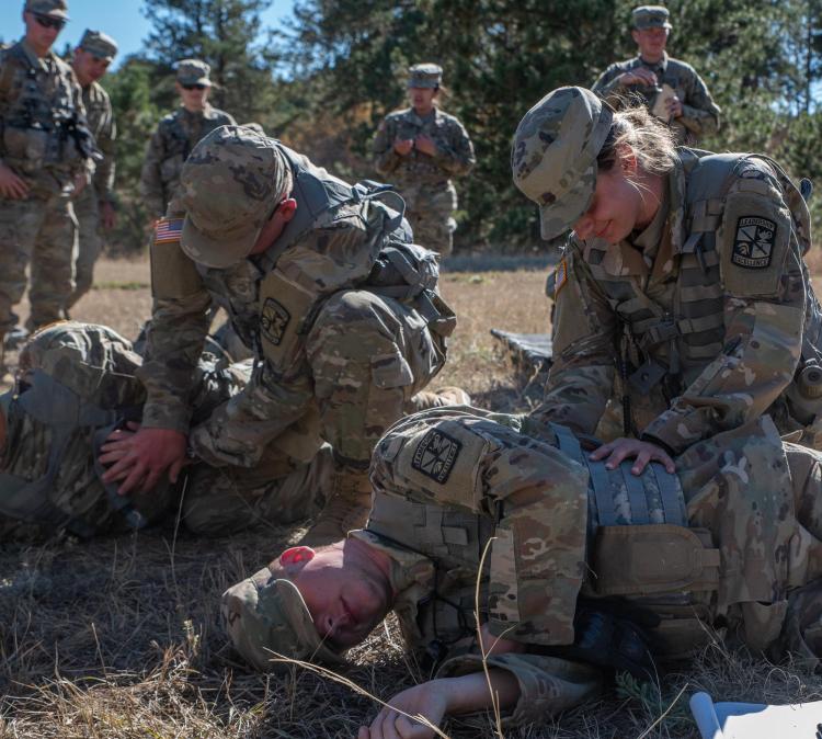 Cadets learning proper medical treatment techniques in the field. Photo courtesy of Cadet Arianna Decker.