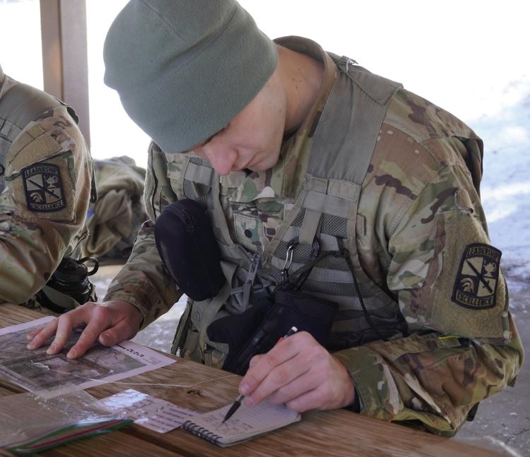 An Army ROTC Cadet studies a map during a land navigation test. Photo courtesy of CDT William Vlad.