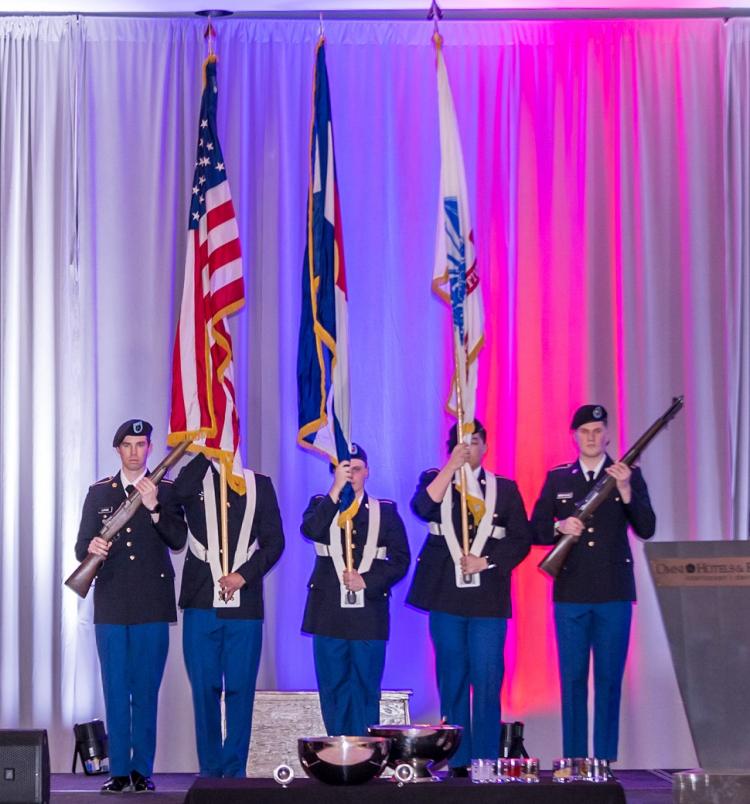 Army ROTC Color Guard preparing to post the colors on stage. Photo courtesy of Elevate Business Photography.