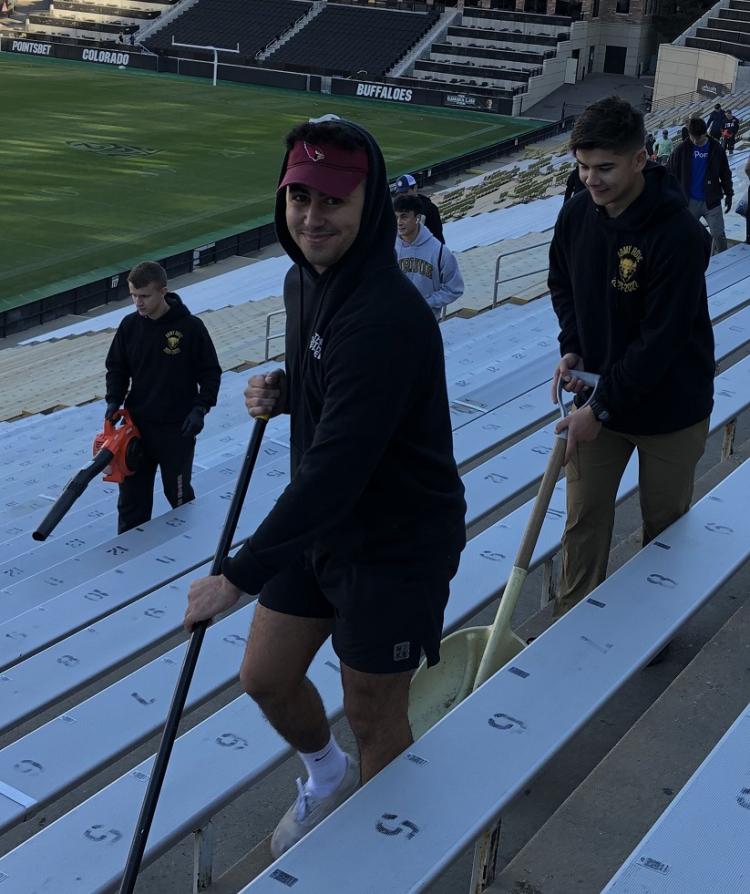 Army ROTC Cadets in good spirits as they sweep, shovel and blow the remaining debris from the stands. Photo courtesy of the Golden Buffalo Battalion.