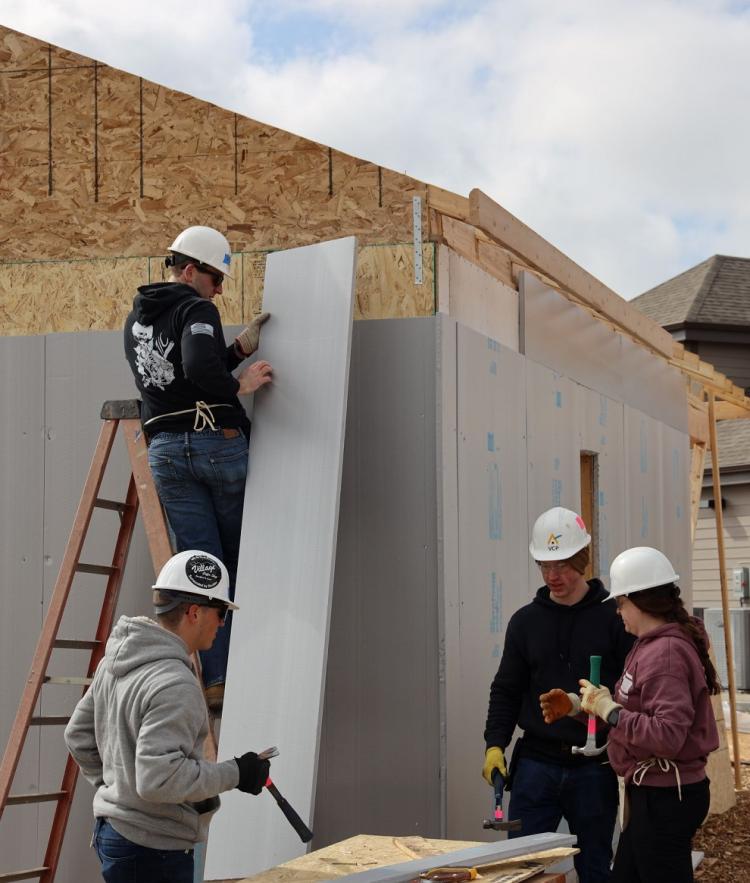 ACO Cadets affixing the “blue boards” to the exterior of a tiny home. Photo courtesy of Rex Laceby.