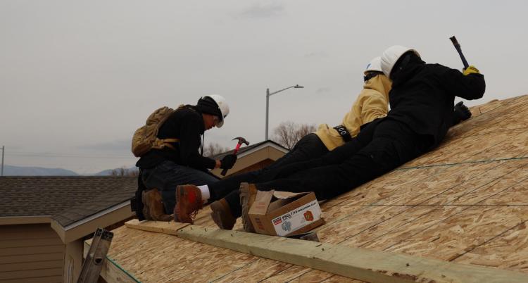 Volunteers hammering down plywood to the roof of a tiny home. Photo courtesy of Rex Laceby.