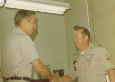 SGM John Anderson, shaking hands with unknown person.