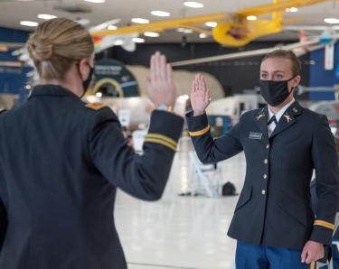 Major Jennifer Staton [left] does the honor of swearing in the Oath of Office to Cadet Emily Cosgrove. Photo courtesy of Cadet Arianna Decker.