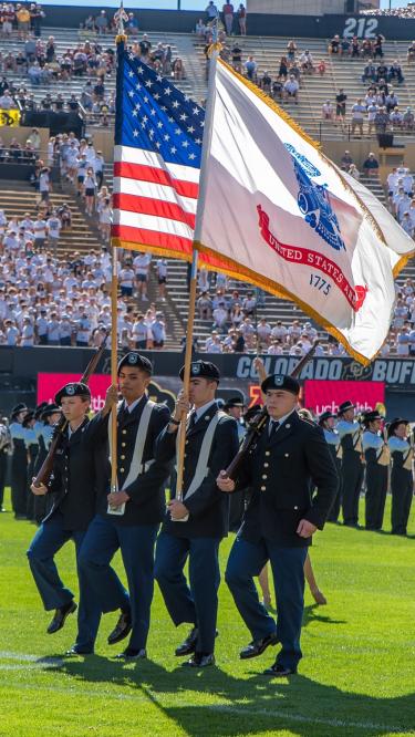 Color Guard making the turn on Folsom Field. Photo courtesy of Cadet Arianna Decker.