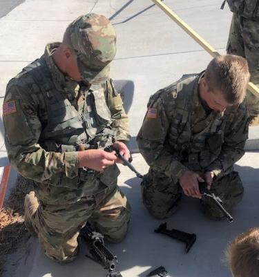 CDT Mauger and CDT Dobrotka show their skills with assembling and disassembling weapons. Photo courtesy of SFC Kevin Marquardt.