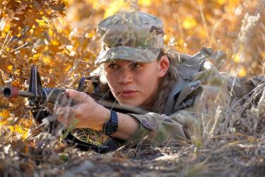 Cadet Fleckenstein (MSIII), selects a suitable coverage location to set up her defensive position during the platoon training lane. Photo courtesy of Cadet William Vlad.