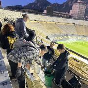 Army ROTC Cadet dumping out liquids into a bucket during the Stadium Clean-up on Sunday. Photo courtesy of the Golden Buffalo Battalion.