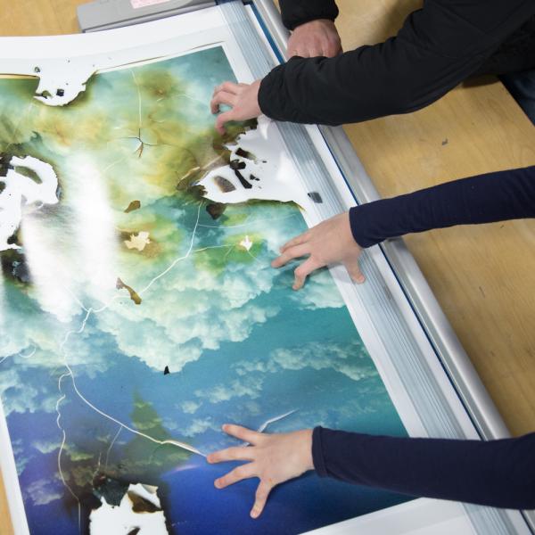 students working on mounting a photograph in the Digital Output Lab