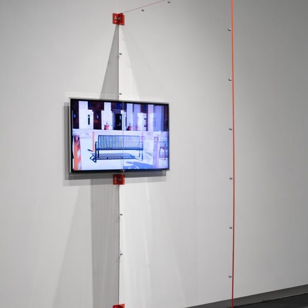 “Plexi Partition: 40 Inch Monitor, The University of Colorado Art Museum, Boulder CO,” 2021 Shaped Plexiglass, metal brackets, and hardware.
