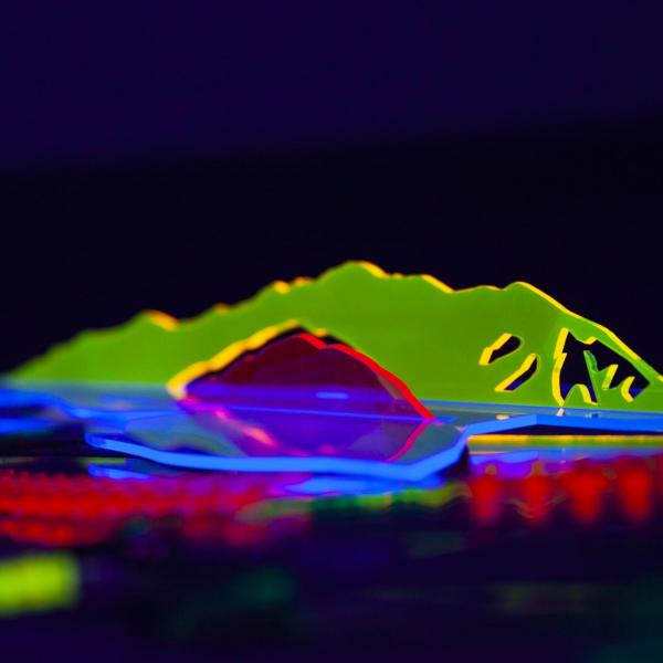 Almost Heard: whispers of the desert. Laser cut transparent acrylic and acrylic mirrors, black light and phone flash lights. 6’ x 2’. 2021