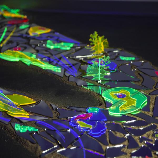Almost Heard: whispers of the desert. Laser cut transparent acrylic and acrylic mirrors, black light and phone flash lights. 6’ x 2’. 2021