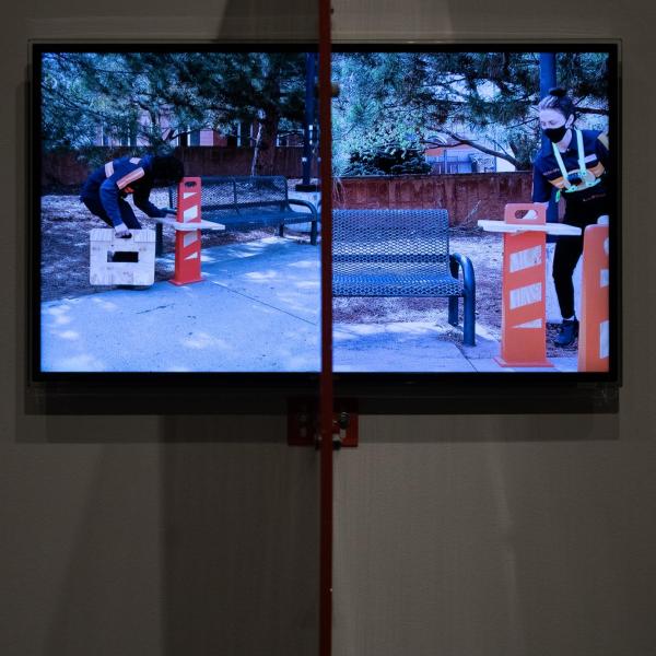 “Plexi Partition: 40 Inch Monitor, The University of Colorado Art Museum, Boulder CO,” 2021 Shaped Plexiglass, metal brackets, and hardware.
