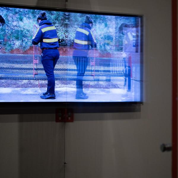 “Plexi Partition: 40 Inch Monitor, The University of Colorado Art Museum, Boulder CO,” 2021 Shaped Plexiglass, metal brackets, and hardware.