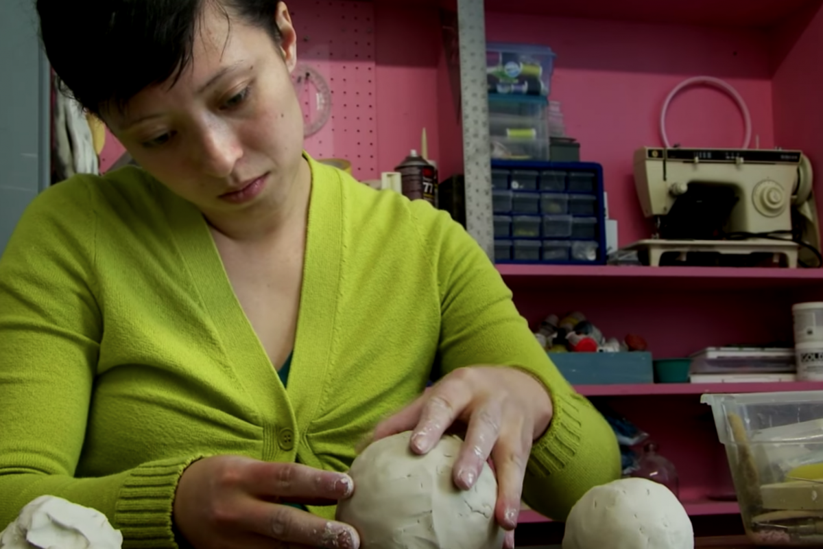 student working on sculpture in studio
