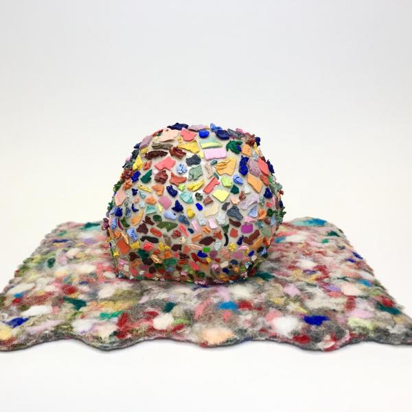 Katie McColgan (MFA). Pet Rock on Magic Carpet Gouache, ceramic, yarn scraps. 9” x 6.5” x 4.5”