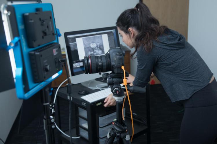 Student editing images in the Portfolio Room