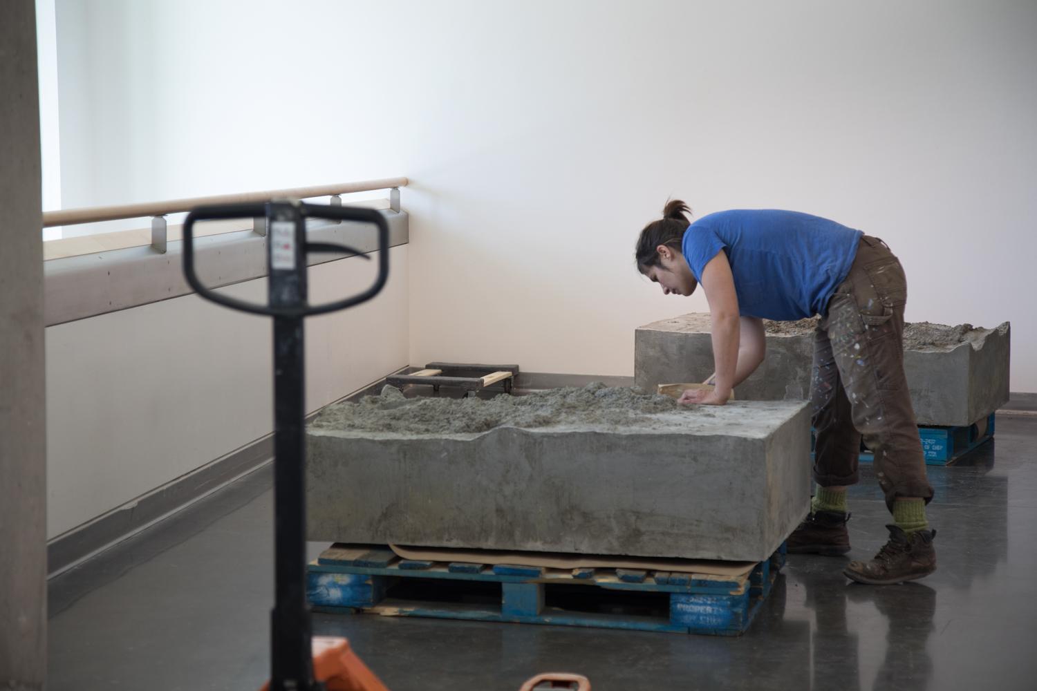Sculpture student installing exhibtion