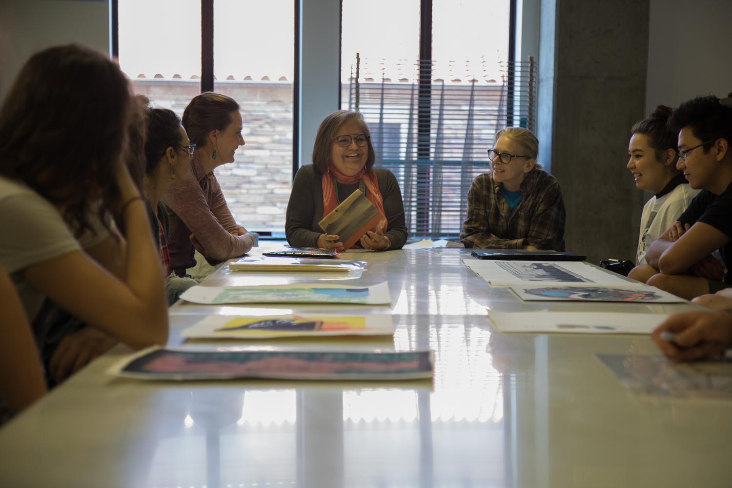 Melanie Yazzie talking to students in printmaking critique