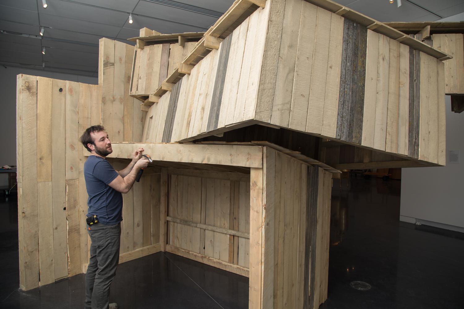 Aaron Treher installing work in the CU Art Museum