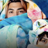 Alejandra Abad and Román Anaya, collaboratively known as Abad◮Anaya, pose draped in hand-colored fabrics. (Credit: Alejandra Abad and Román Anaya) 