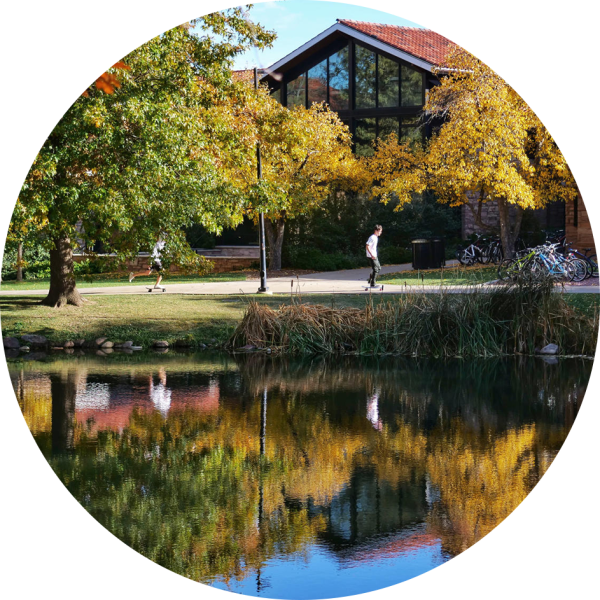 A student is seen skateboarding past Smith Hall, where the A&S Honors RAP is housed.