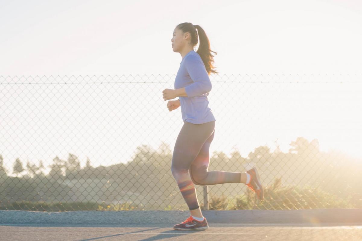 A girl running around a track