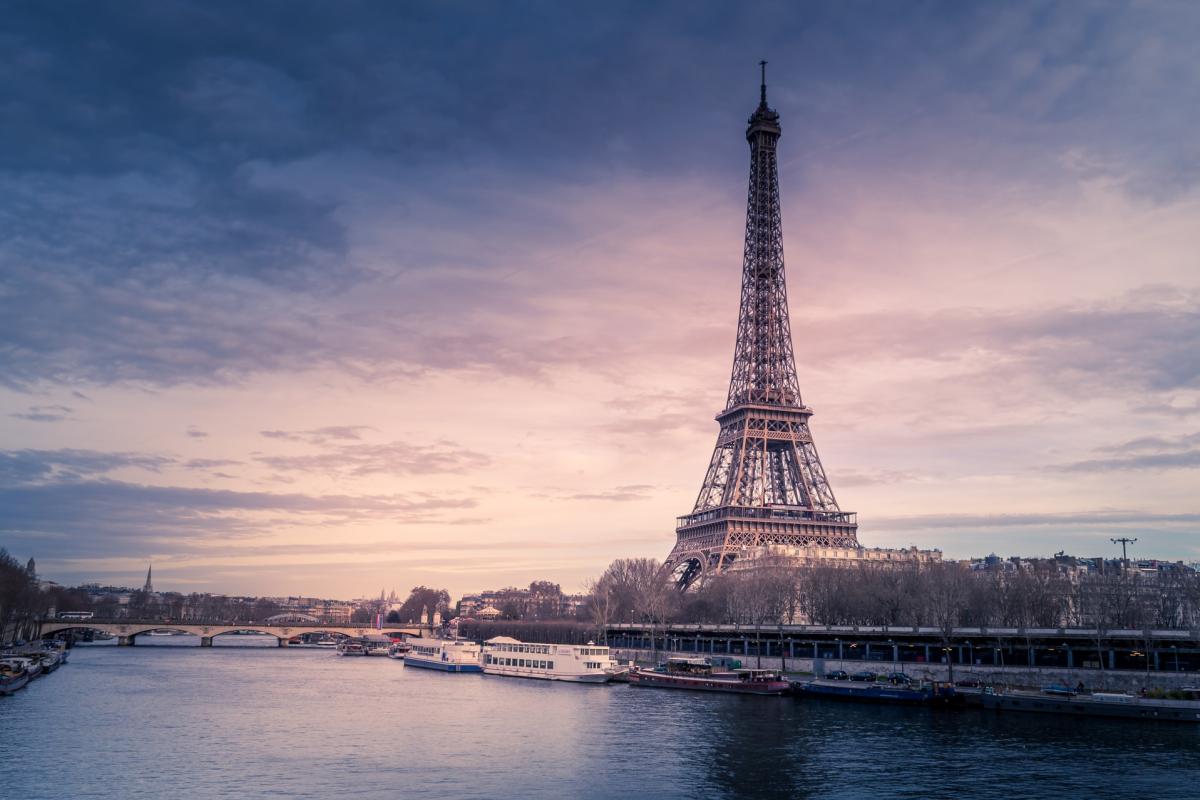 The Eiffel Tower is seen at dusk.