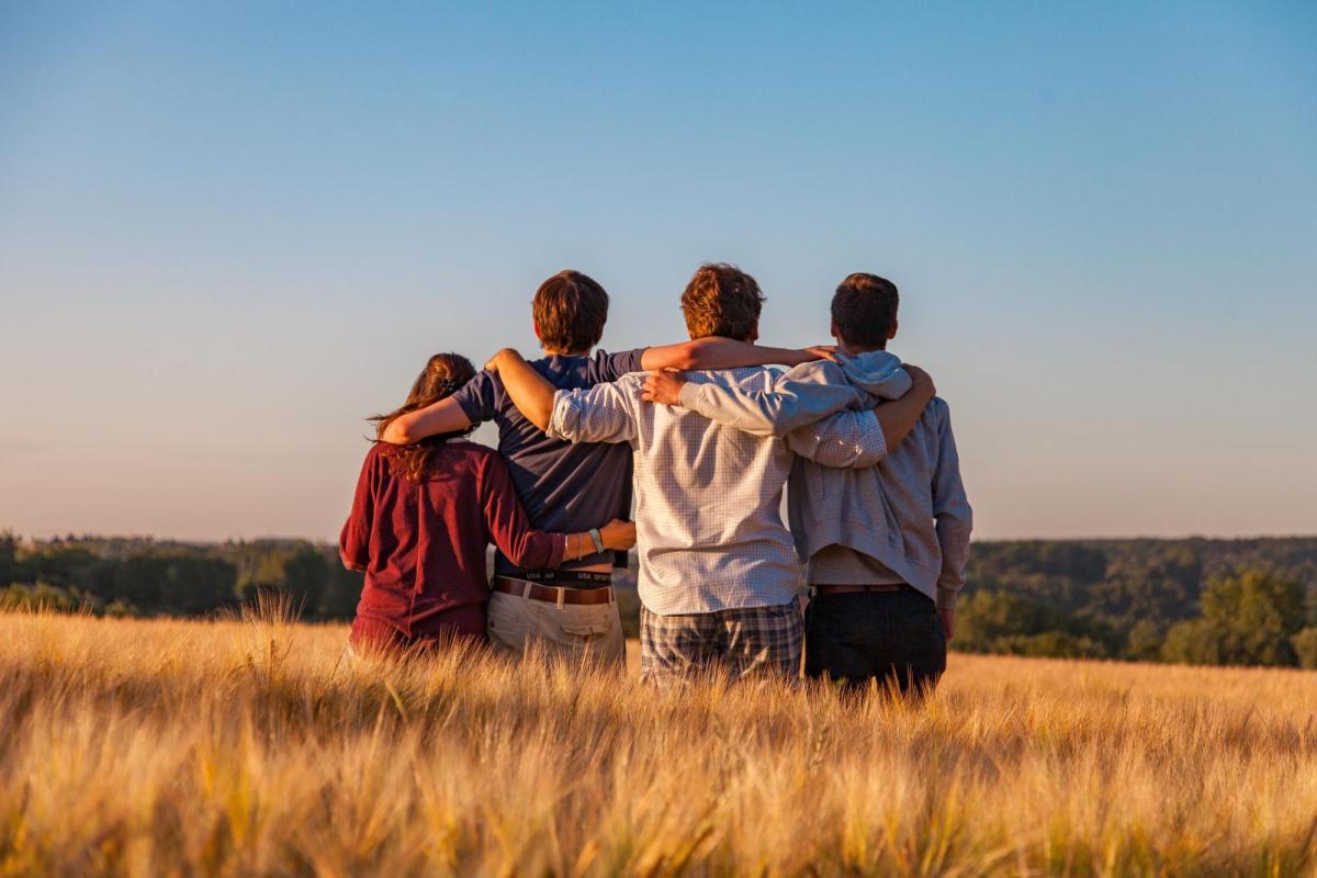 Friends standing in a field