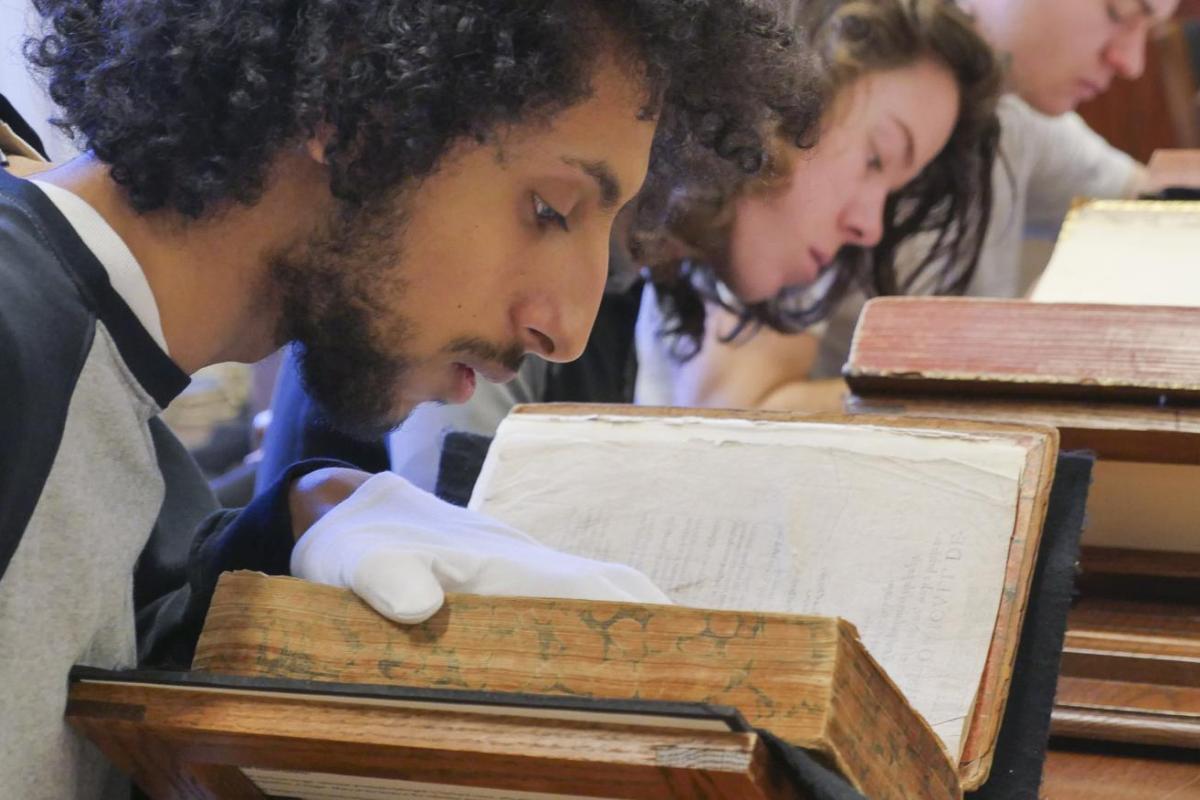 Student looking at old books