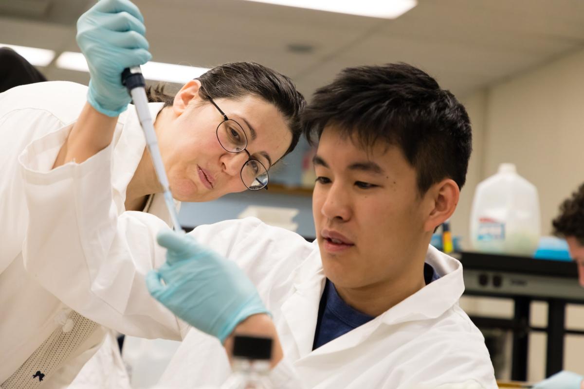Students in the Drug Discovery lab learn how to use equipment like a pipette.