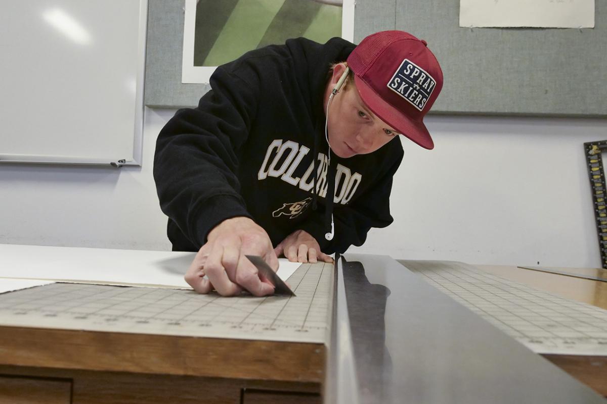 Photo of an art student doing printmaking
